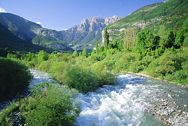 Torla, the River Ara and distant Mondarruego, Huesca (Pyrenees), Aragon, Spain, Europe