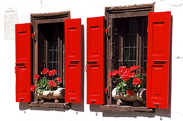 Red shuttered windows and geraniums, Tasch, near Zermatt, Valais, Switzerland, Europe