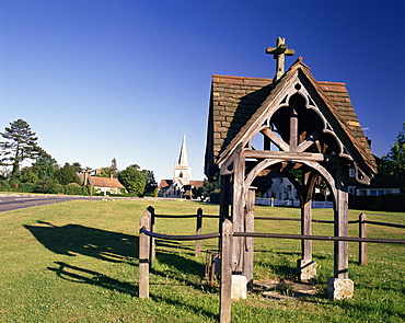 Pump, village green and church in the distance, Brockham, near Dorking, Surrey, England, UK, Europe