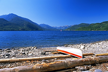 Upturned canoe on the rocky eastern shore of Slocan Lake, New Denver, British Columbia (B.C.), Canada, North America