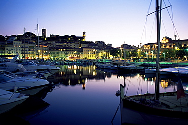 View across harbour to the old quarter of Le Suquet, at dusk, Cannes, Alpes-Maritimes, Cote d'Azur, French Riviera, France, Mediterranean, Europe