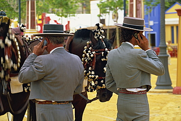 Men in traditional dress using mobile phones, Feria del Caballo (Horse Fair), Jerez de la Frontera, Cadiz area, Andalucia (Andalusia), Spain, Europe