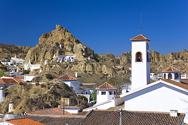 View across rooftops to cave houses in the troglodyte district, Guadix, Granada, Andalucia (Andalusia), Spain, Europe