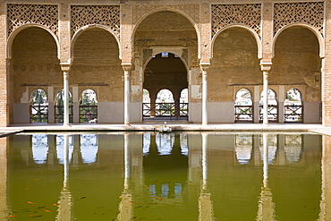 Portico of the Torre de las Damas reflected in tranquil pool, Jardines del Partal, Alhambra, UNESCO World Heritage Site, Granada, Andalucia (Andalusia), Spain, Europe