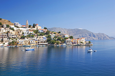 View across the tranquil waters of Harani Bay, Gialos (Yialos), Symi (Simi), Rhodes, Dodecanese Islands, South Aegean, Greece, Europe