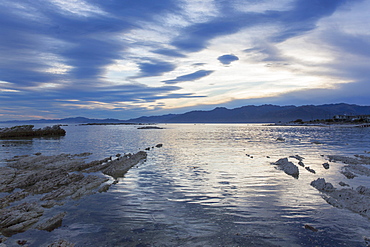 View across the tranquil waters of South Bay at dusk, Kaikoura, Canterbury, South Island, New Zealand, Pacific