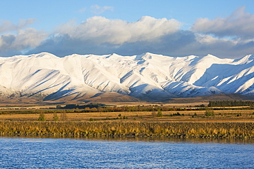 The Ben Ohau Range cloaked in autumn snow, the Pukaki Canal in foreground, Twizel, Mackenzie district, Canterbury, South Island, New Zealand, Pacific