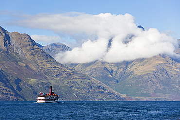 The steamship TSS Earnslaw on Lake Wakatipu, clouds over Walter Peak, Queenstown, Queenstown-Lakes district, Otago, South Island, New Zealand, Pacific