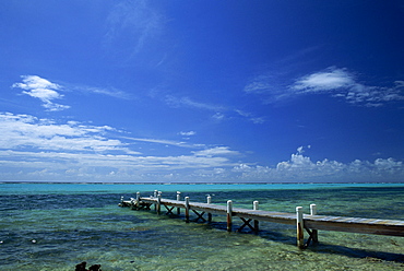 Waves breaking on reef on the horizon, with jetty in foreground, Grand Cayman, Cayman Islands, Caribbean, Central America