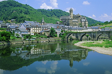 Village reflected in the Lot River, Estaing, Aveyron, Midi Pyrenees, France, Europe