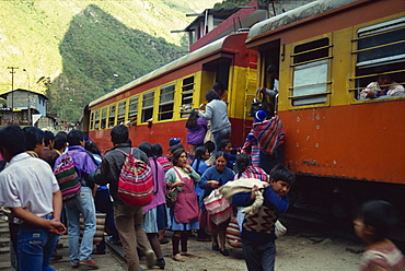 Passengers leaving and boarding the train at the railway station at Aguas Calientes below Machu Picchu in Peru, South America