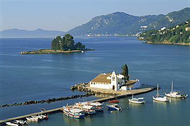 Moored boats beside pier leading to Vlacherna Monastery, Kanoni, Corfu, Ionian Islands, Greek Islands, Greece, Europe