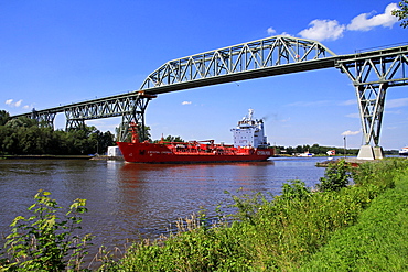 Ship on Kiel Canal going under the Railway Bridge of Hochdonn, Dithmarschen, Schleswig-Holstein, Germany, Europe