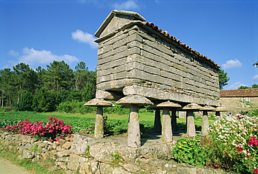 A galego horrero, granite granary with anti-rodent discs on legs, a typical building in Galicia, Spain, Europe