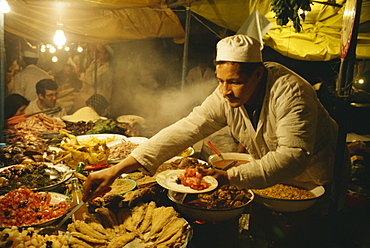 Portrait of a man serving food from his stall in the Djemaa el Fna market in Marrakesh, Morocco, North Africa, Africa