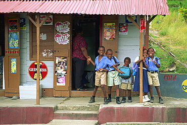 Portrait of schoolchildren waiting for bus outside a shop, near Roxborough, Tobago, West Indies, Caribbean, Central America