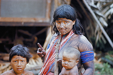 Heavily painted Tirio Indian woman wearing beads, with children, Brazil, South America