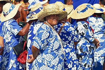 Portrait of a group of women in blue and white dresses, wearing straw hats, in a parade on Independence Day in Apia, on Upolu, Western Samoa, Pacific Islands, Pacific