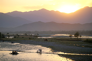 Crossing river at dusk, near Mingora, Swat Valley, Pakistan, Asia