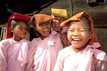 Portrait of four mischievous nuns, Meiktila, Myanmar (Burma), Asia