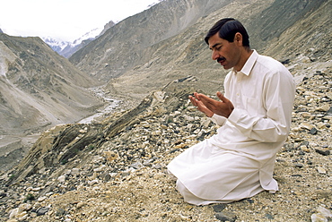 Muslim driver praying, Karakorum Highway, north of Karimabad, Hunza Valley, Pakistan, Asia