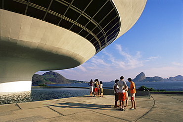 People looking at view across bay to Rio from Museo de Arte Contemporanea, by Oscar Niemeyer, Rio de Janeiro, Brazil, South America