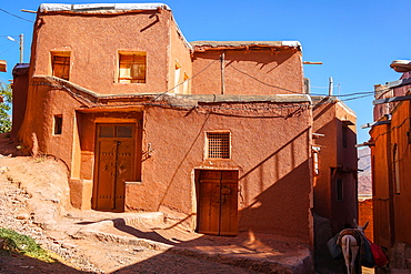 Winding lanes and donkey in 1500 year old traditional village of red mud brick houses, Abyaneh, Iran, Middle East