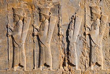 Carved relief of four Royal Persian Guards, facade of Private Palace of Darius the Great (Tachara), Persepolis, UNESCO World Heritage Site, Iran, Middle East