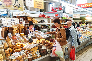 Shopping at the baker's in the covered Central Market, converted Zeppelin hangars, Riga, Latvia, Europe