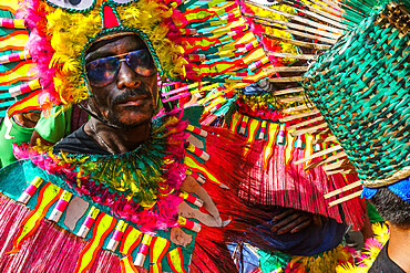 Cool participant in dark glasses and flamboyant coloured dress at the annual Ati-Atihan Festival, Kalibo Island, Philippines, Southeast Asia, Asia