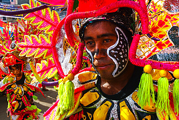 Two participants in flamboyant coloured dress marching at the annual Ati-Atihan Festival, Kalibo Island, Philippines, Southeast Asia, Asia