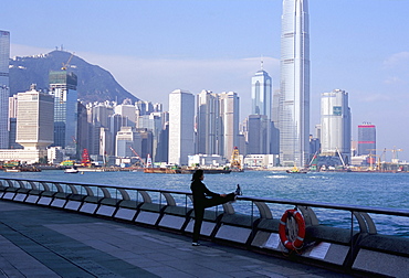 Morning exercise, Victoria Harbour and Hong Kong Island skyline, Hong Kong, China, Asia