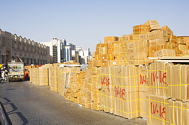 Goods stacked on the dockside of the Dhow Wharfage awaiting transportation by dhow to ports throughout the Middle East, India and Asia, Dubai Creek, Dubai, United Arab Emirates, Middle East