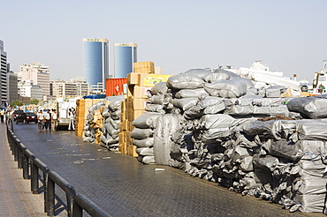 Goods stacked on the dockside of the Dhow Wharfage awaiting transportation by dhow to ports throughout the Middle East, India and Asia, Dubai Creek, Dubai, United Arab Emirates, Middle East