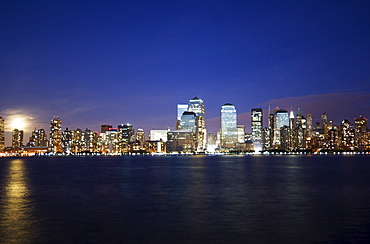 Full moon rising over Lower Manhattan skyline across the Hudson River, New York City, New York, United States of America, North America