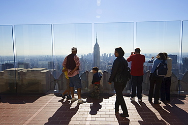 Tourists looking at the Empire State Building and Manhattan skyline from the Top of the Rock on the Rockefeller Center, New York City, New York, United States of America, North America