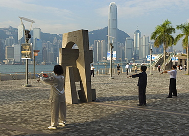 Early morning Tai Chi class on the Tsim Sha Tsui waterfront, Kowloon, Hong Kong, China, Asia