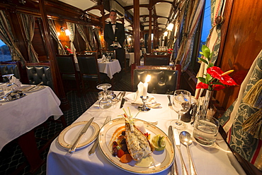 Dinner in the galleried wood panelled Edwardian vintage dining coach, Rovos Rail, South Africa, Africa