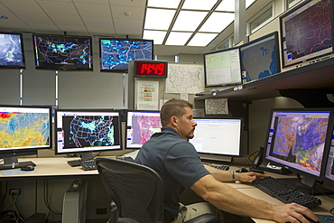 On duty meteorologist Corey Meade at the Storm Prediction Centre, National Weather Center, Norman Oklahoma, United States of America, North America