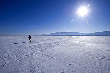 Runners in the 10th Baikal Ice marathon, run on the frozen surface of the world's largest fresh water lake on March 1st 2014, Siberia, Russia, Eurasia