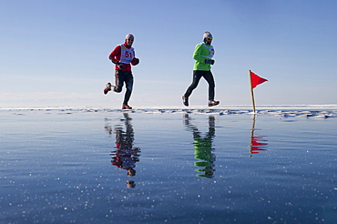 Runners in the 10th Baikal Ice Marathon, run on the frozen surface of the world's largest fresh water lake on 1st March 2014, Siberia, Irkutsk Oblast, Russia, Eurasia