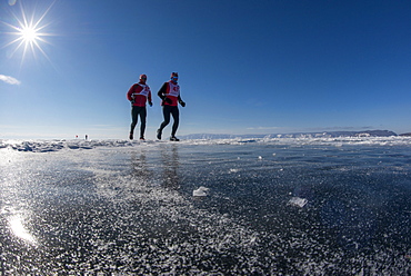 Runners in the 10th Baikal Ice Marathon, run on the frozen surface of the world's largest fresh water lake on 1st March 2014, Siberia, Irkutsk Oblast, Russia, Eurasia