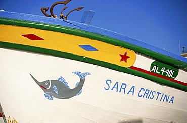 Detail of painted side of a fishing boat in the Algarve, Portugal, Europe