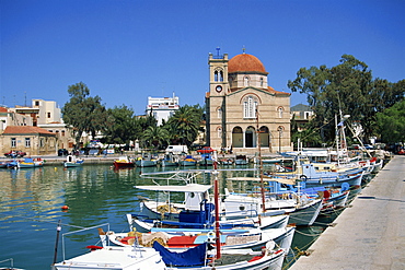 Fishing boats moored in harbour and domed church, Aegina Town, Aegina, Saronic Islands, Greek Islands, Greece, Europe