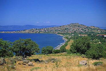 Coastline and bay with the town of Molyvos on a hill in the background, on Lesbos, North Aegean Islands, Greek Islands, Greece, Europe