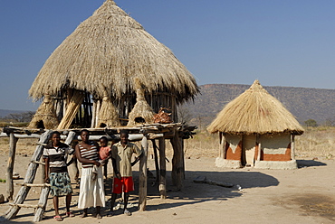 Ttraditional  thatch roofed house and grain storage, Lake Kariba, Zimbabwe, Africa