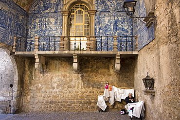 Old lady selling embroidery in the walled medieval town of Obidos, declared national monument, Estremadura, Portugal, Europe