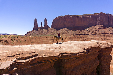 John Ford's Point and the Three Sisters and cowboy on horse, Monument Valley, border of Arizona and Utah, United States of America, North America