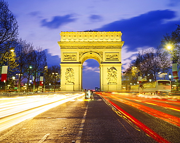 The Arc de Triomphe illuminated at dusk, Paris, France 