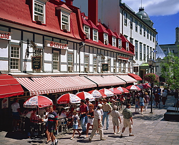 Street scene with hotel, restaurants and pavement cafes on Place d'Armes in Quebec City, Quebec, Canada, North America